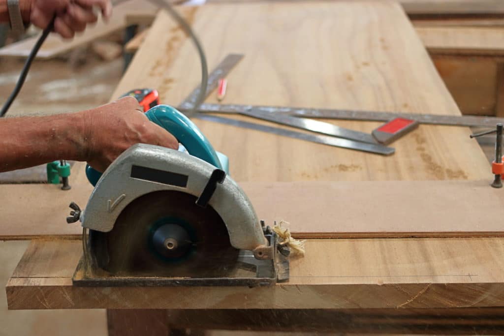 Using a circular saw to cut a table top